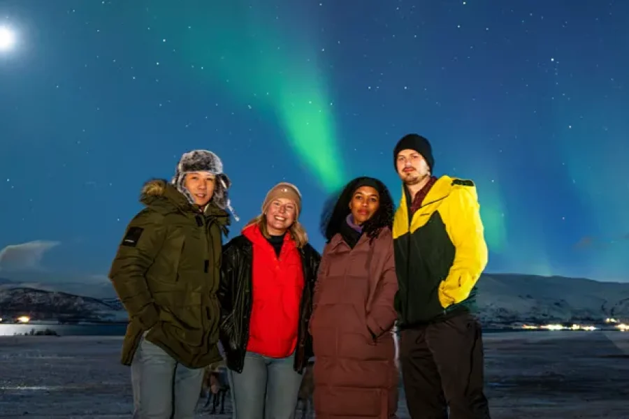 a group of people standing in front of a starry sky