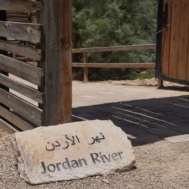 a wooden structure with a stone structure in the desert